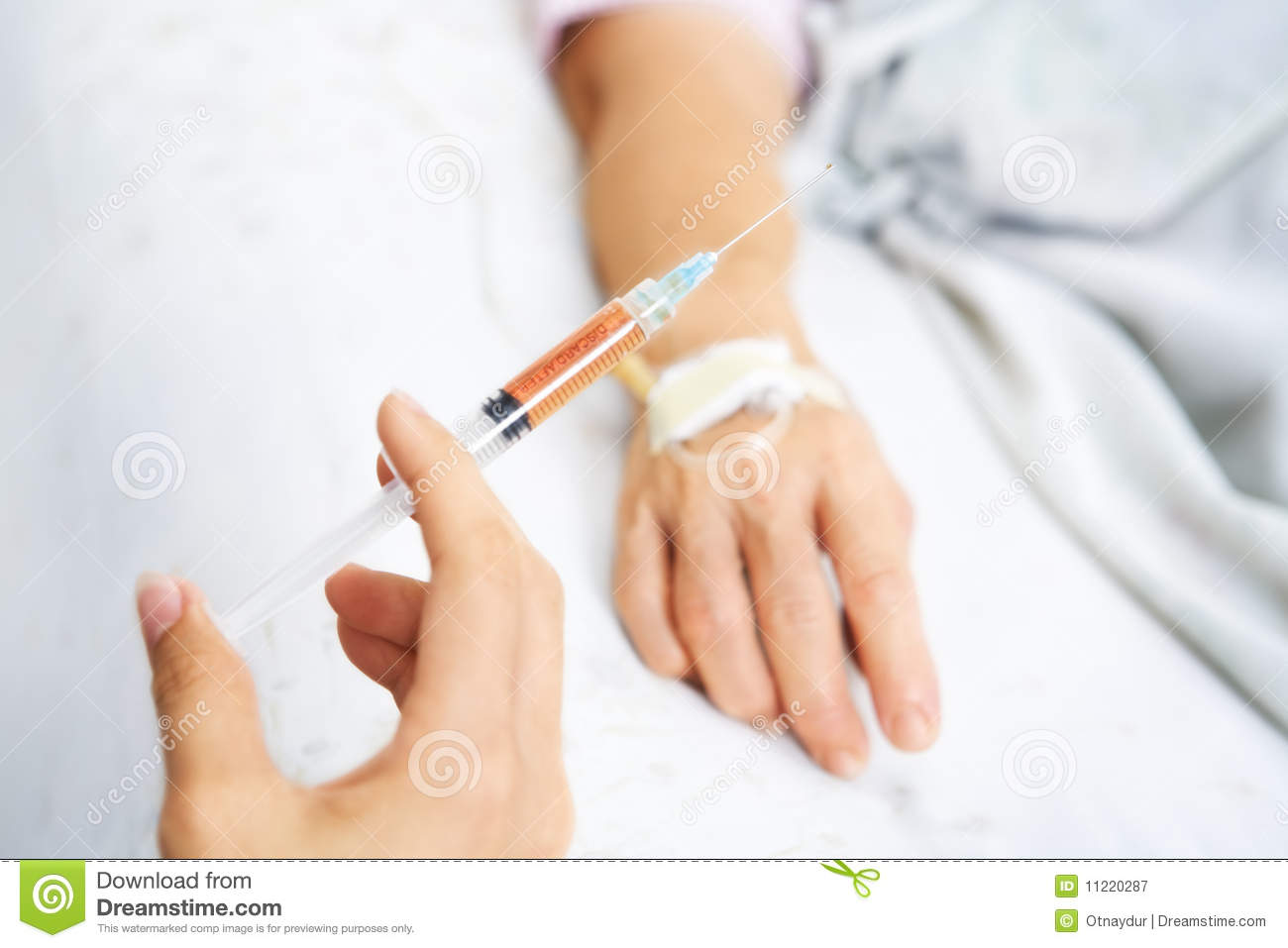 Hand Holding Injection With Patient Hand On Background Focus Mainly