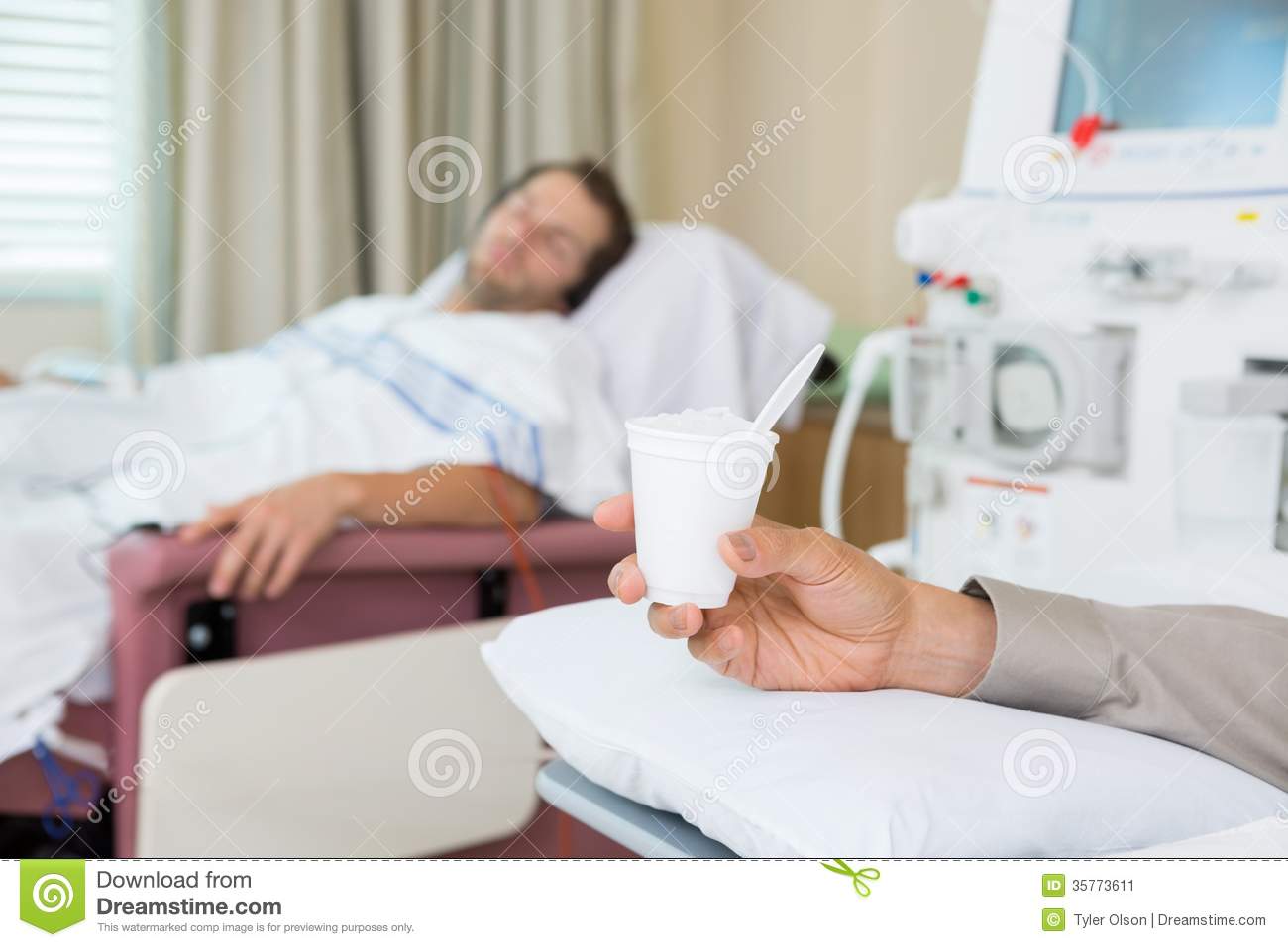 Male Cancer Patient S Hand Holding Glass Of Crushed Ice In Dialysis