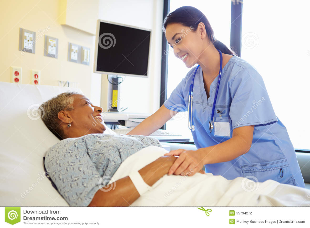 Nurse Talking To Senior Woman In Hospital Room Stock Photography