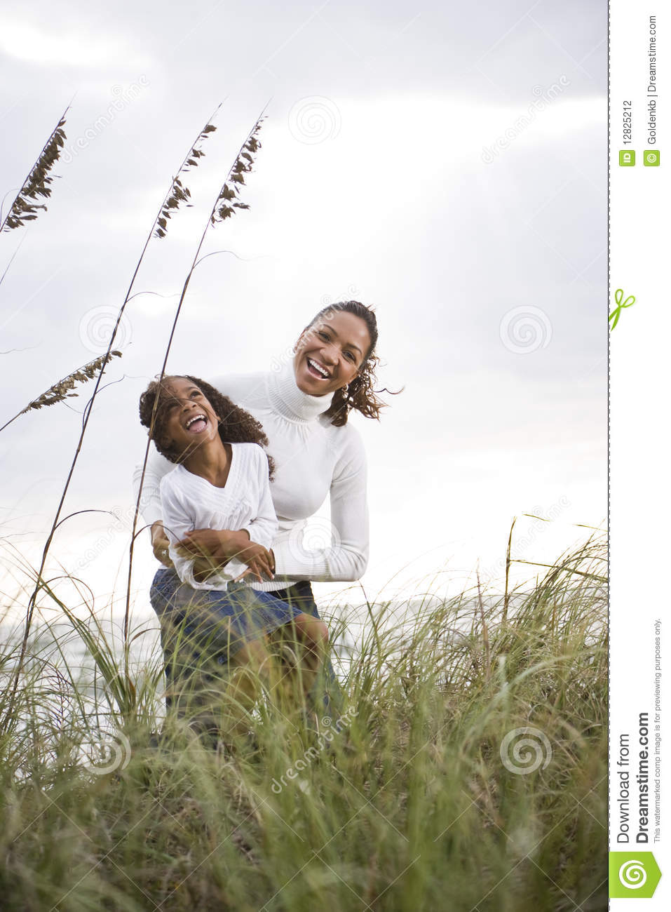 African American Mother Daughter Laughing At Beach Stock Photography