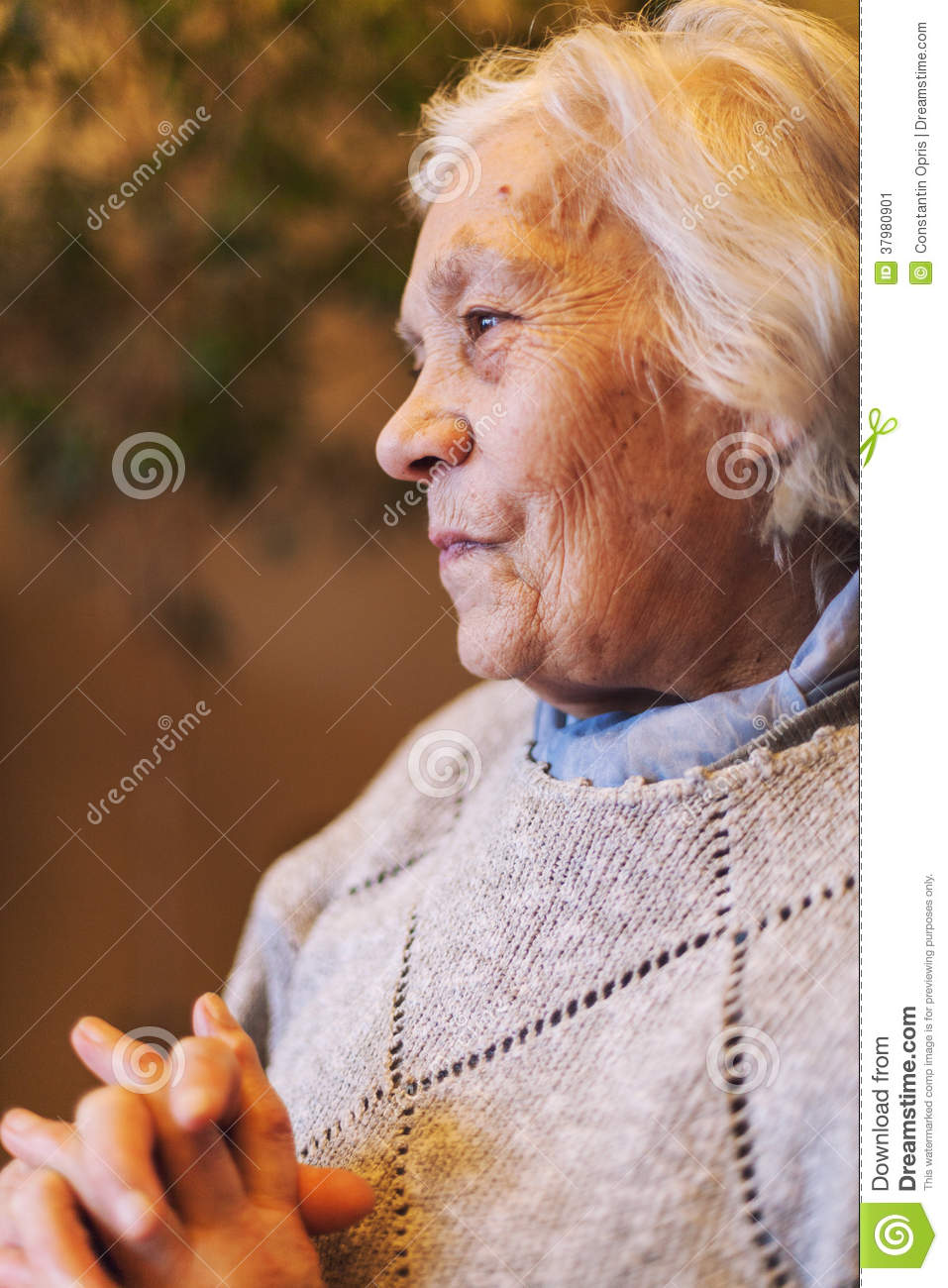 Happy Elder Woman Portrait Sitting And Looking To Side Smiling 