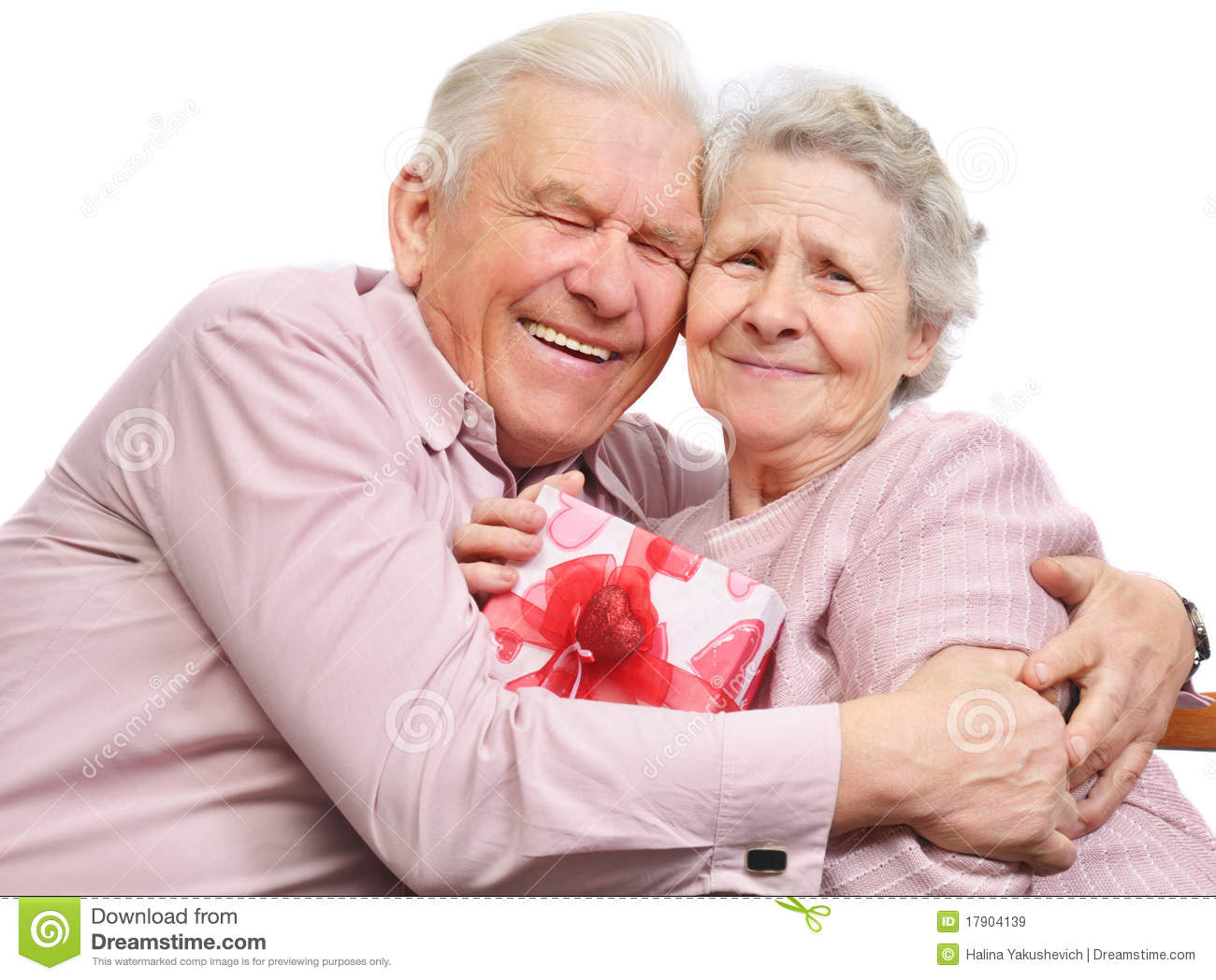 Smiling Elderly Couple And Box With Gift Royalty Free Stock Images    