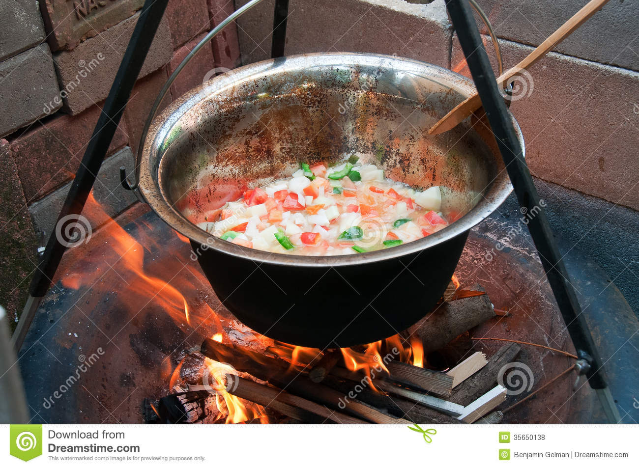 Hungarian Goulash Cooked In A Copper Pot Over A Fire In The Backyard