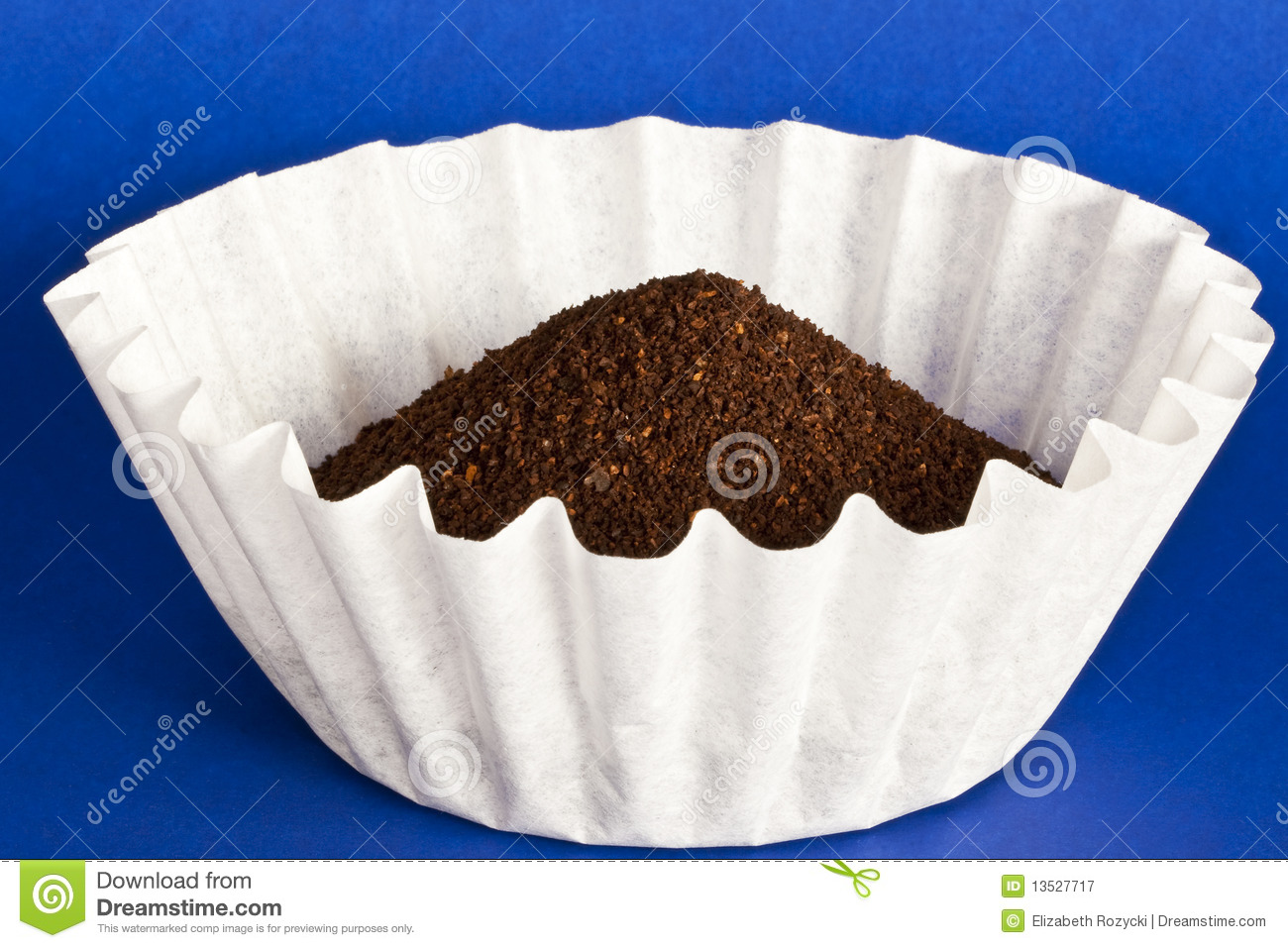 Coffee Grounds Sit In A Coffee Filter On Top Of A Blue Background
