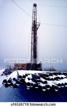 Onshore Oil Drilling Rig With Drill Pipe Stacked In Foreground Covered