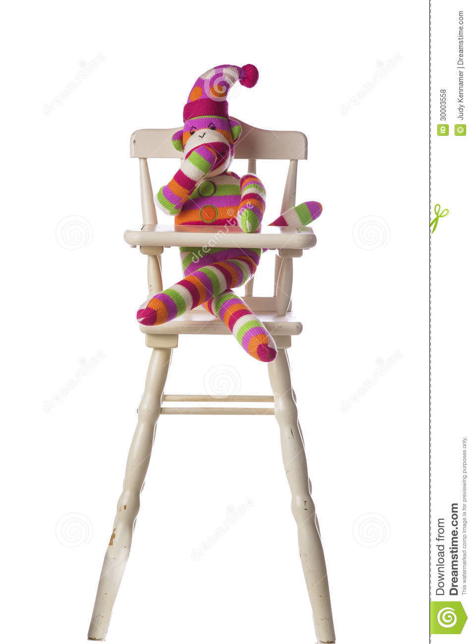 Beautiful Colorful Striped Sock Monkey Sitting In Highchair Isolated
