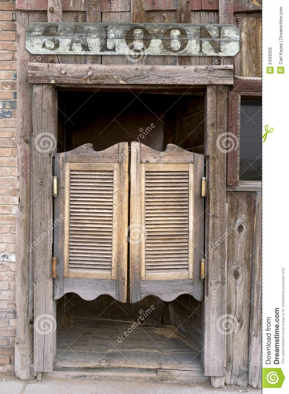 Old Western Swinging Saloon Doors With A Saloon Sign Above Doors