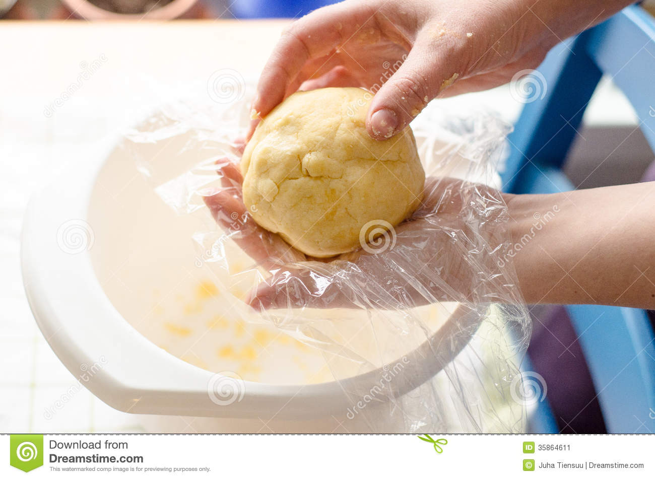 Baker Wrapping A Ready Pie Dough Ball In A Plastic Film For Cooling