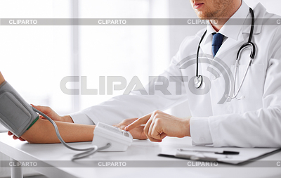       Doctor And Patient Measuring Blood Pressure     Lev Dolgachov