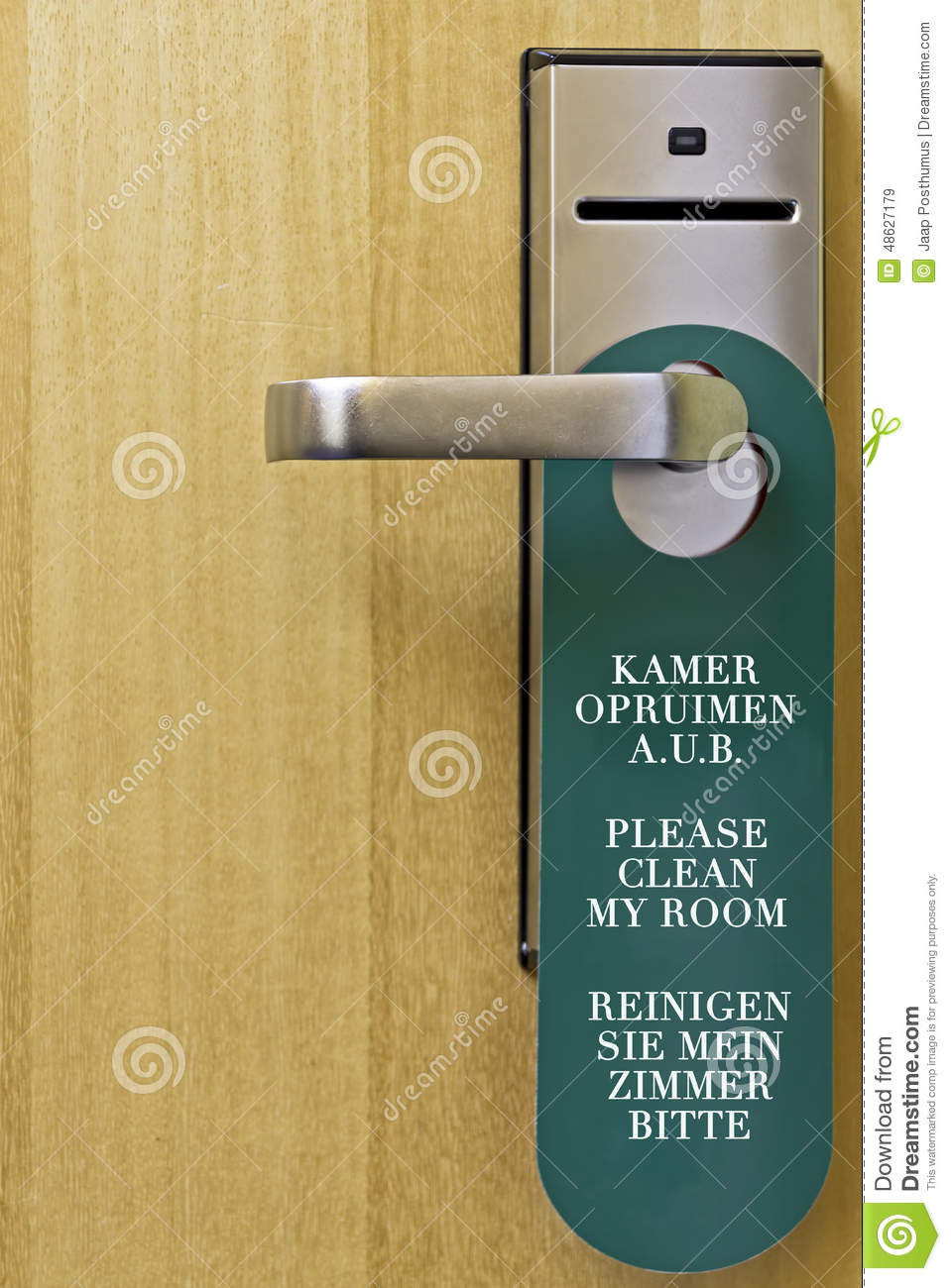 Green Hotel Sign For Cleaning The Room Hanging On A Door Handle With