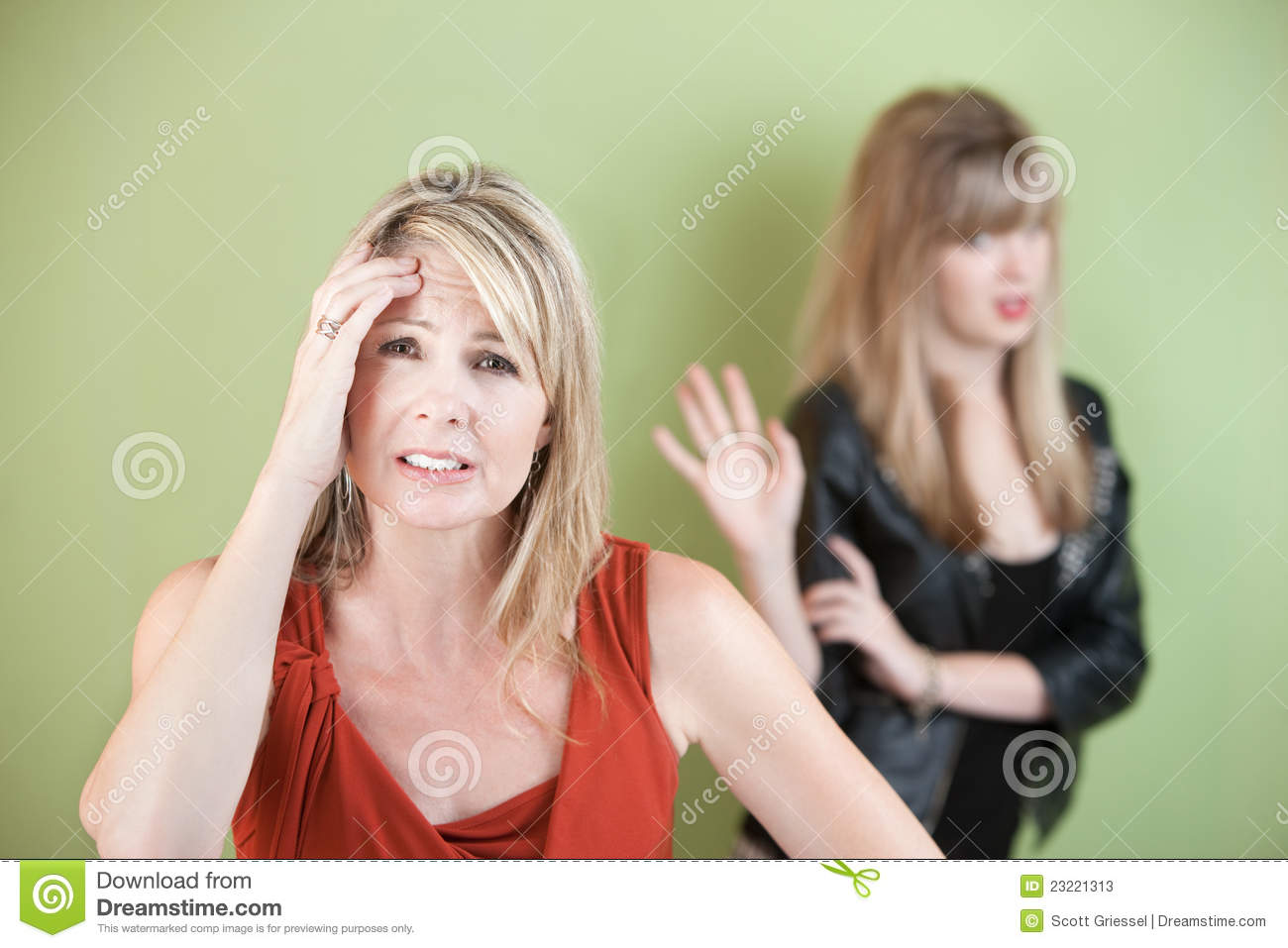 Upset Mom With Frustrated Daughter Over Green Background