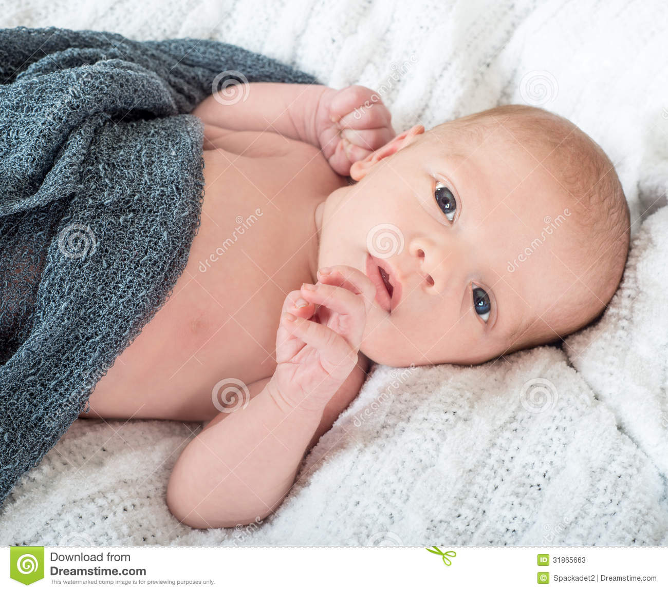 Beautiful Wide Awake Baby Lying On A White Knit Blanket Stock Photos    
