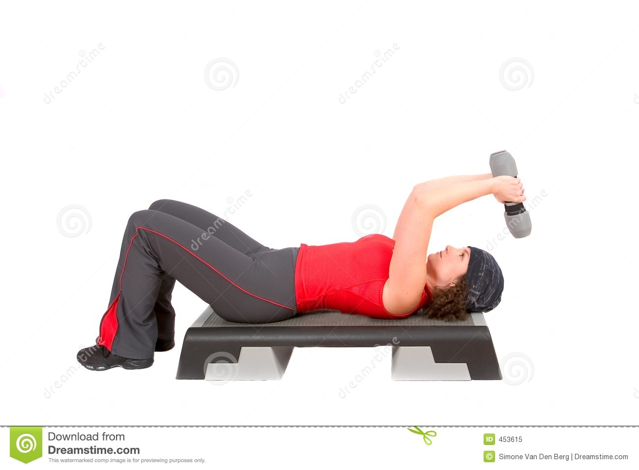 Pretty Woman Doing Triceps Curls While Lying On A Step 