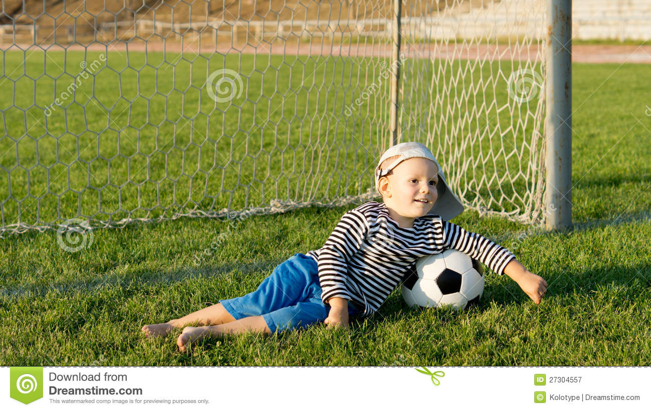 Barefoot Youngster With Soccer Ball Royalty Free Stock Photography    