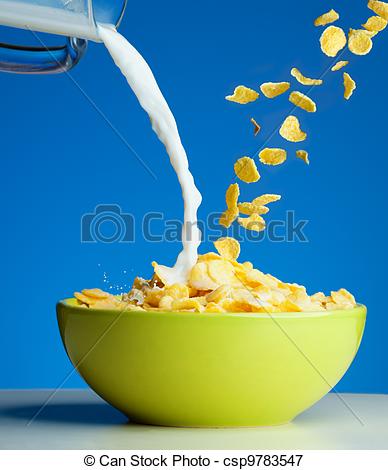 Corn Flakes With Milk Pouring From Glass