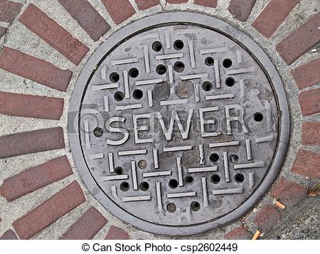 Stock Photographs Of Sewer Manhole Lid   Sewer Manhole Lid In Street