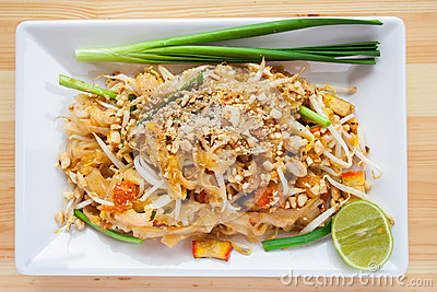 Thai Noodle With Lemon In White Plate Is On The Wooden Table