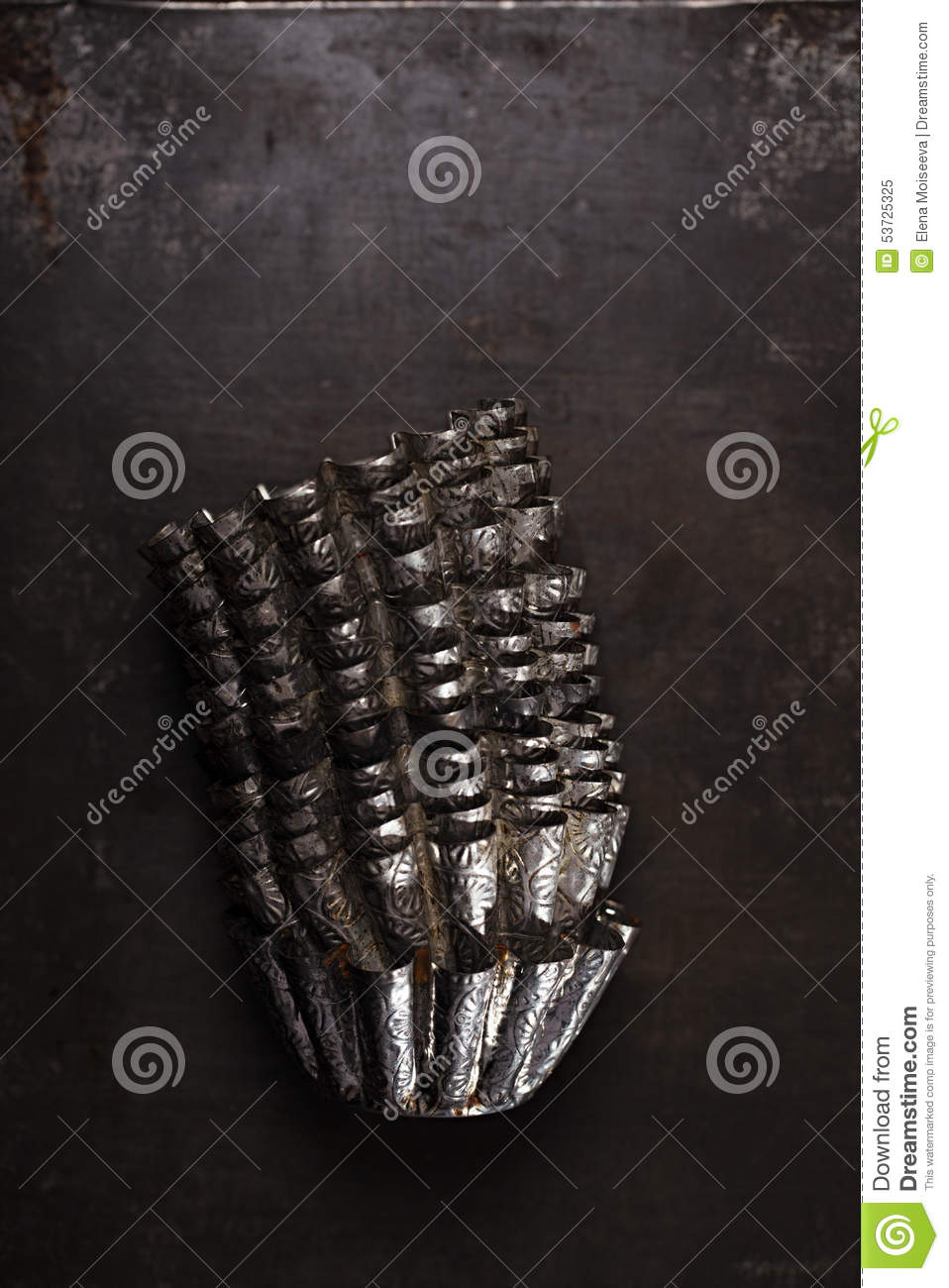 Abstract Picture With Vintage Baking Tins Or Molds Stacked On Dark