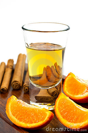 Golden Tequila Shot With Orange And Cinnamon Close Up