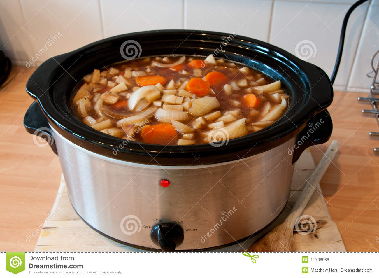 Slow Cooker With Scouse Cooking Standing On A Wooden Board With A