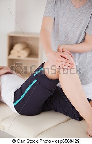 Stock Photo   Portrait Of A Sportswoman Having A Knee Massage   Stock