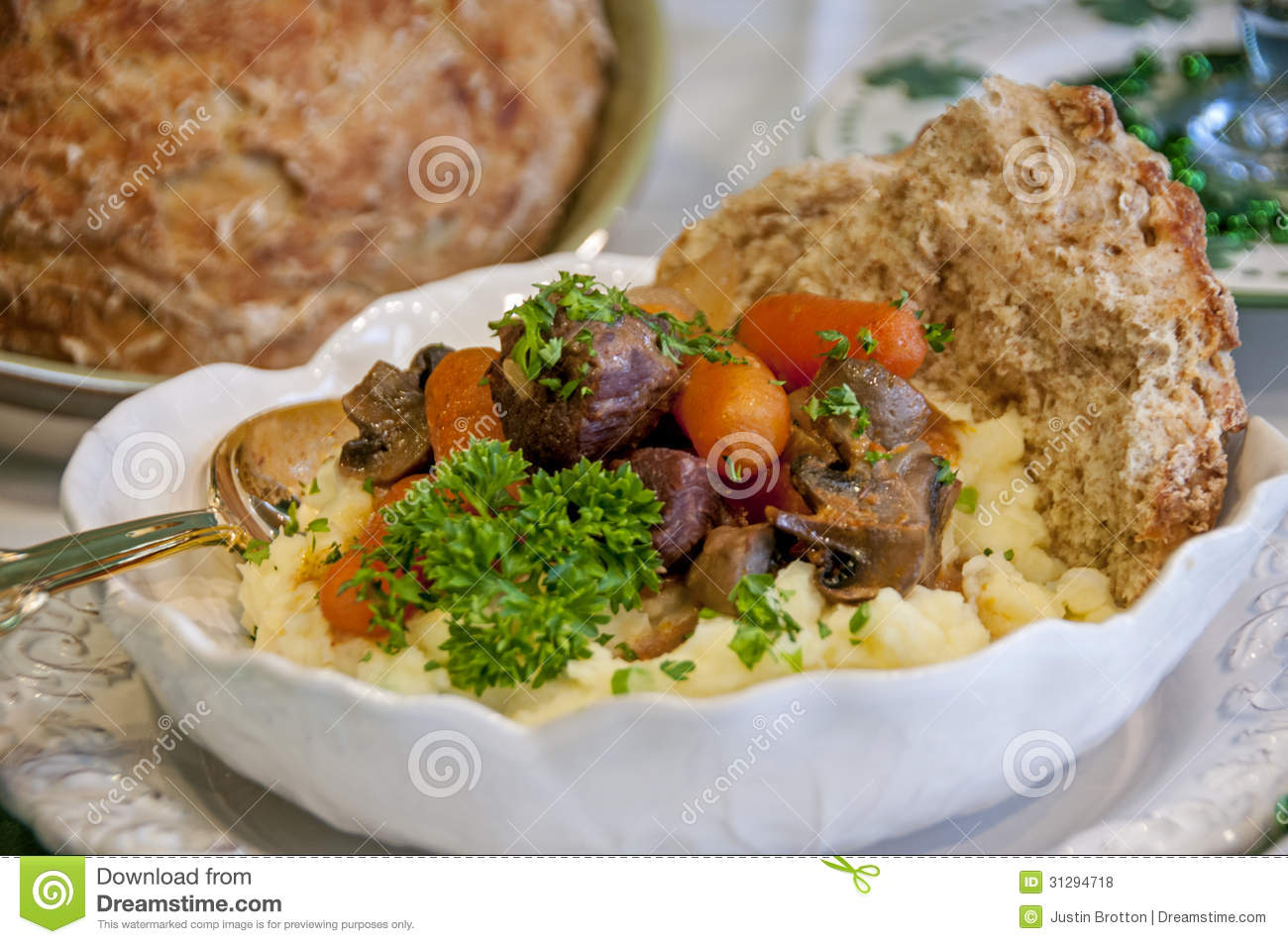 This Is A Beef Stew With Vegetables Over A Mashed Potatoes With A