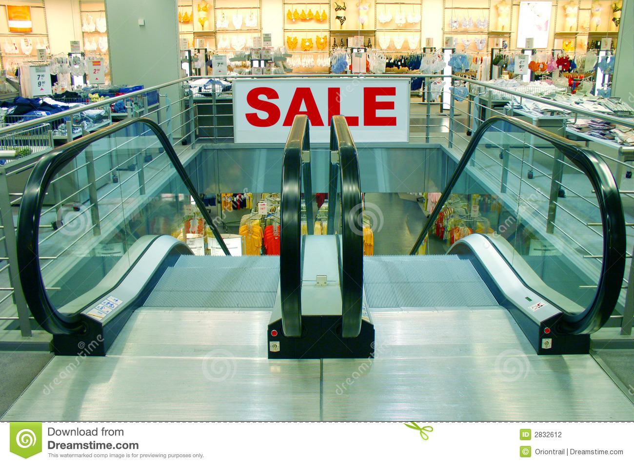 Escalators In A Shopping Mall In Which There Is A Big  Sale  Sign