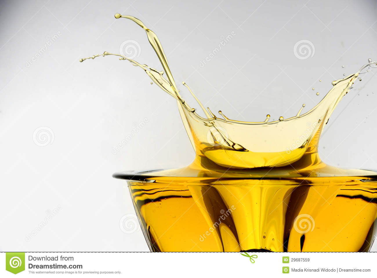 Side View Of Cooking Oil Splashing In Container Studio Background