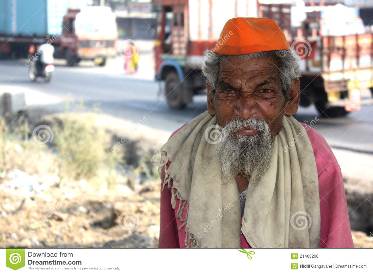 Poor Old Indian Man With A Long Beard In Traditional Attire