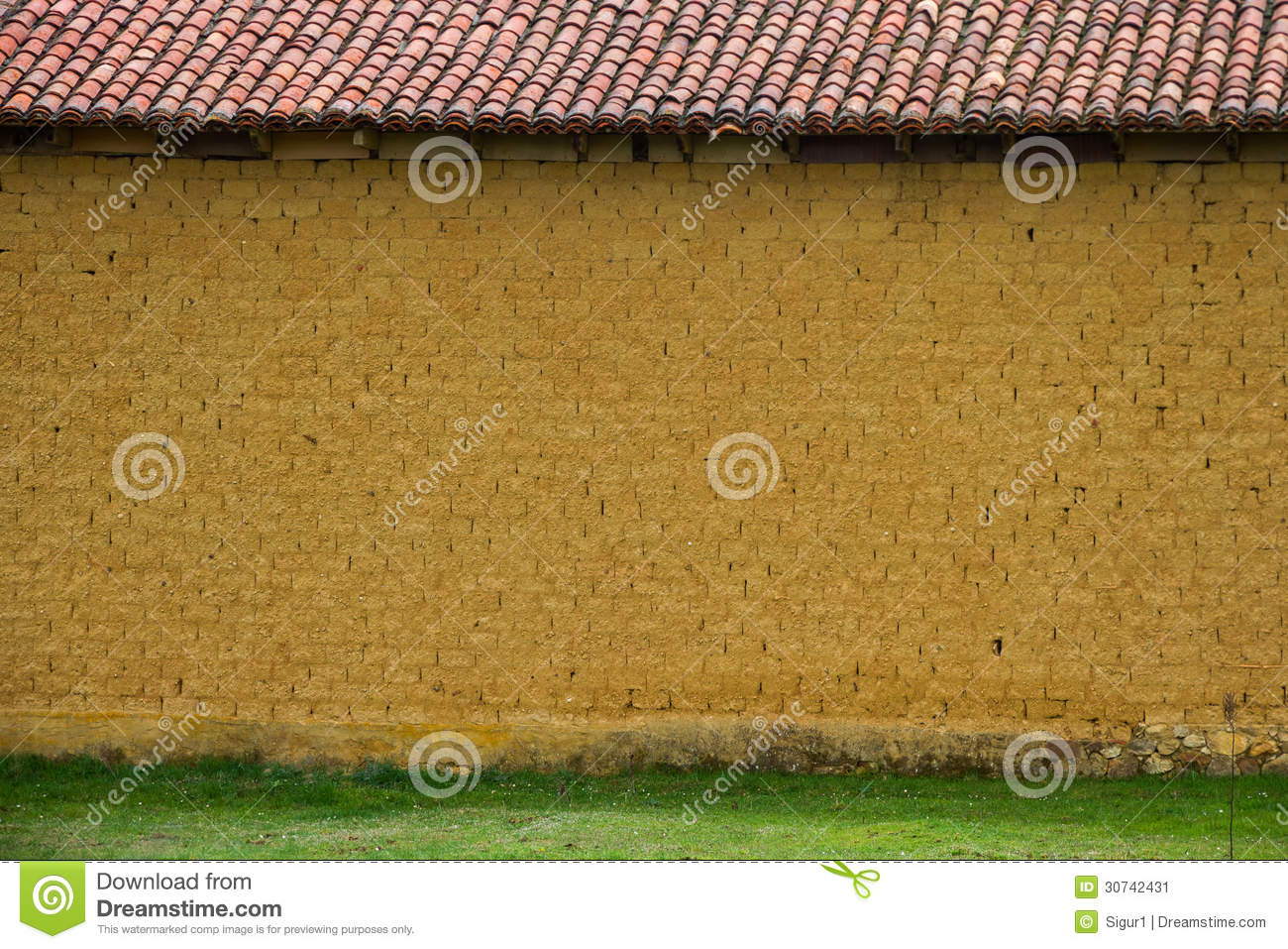Front Wall Of Adobe Or Thatched Mud Bricks Baked In The Sun And Red