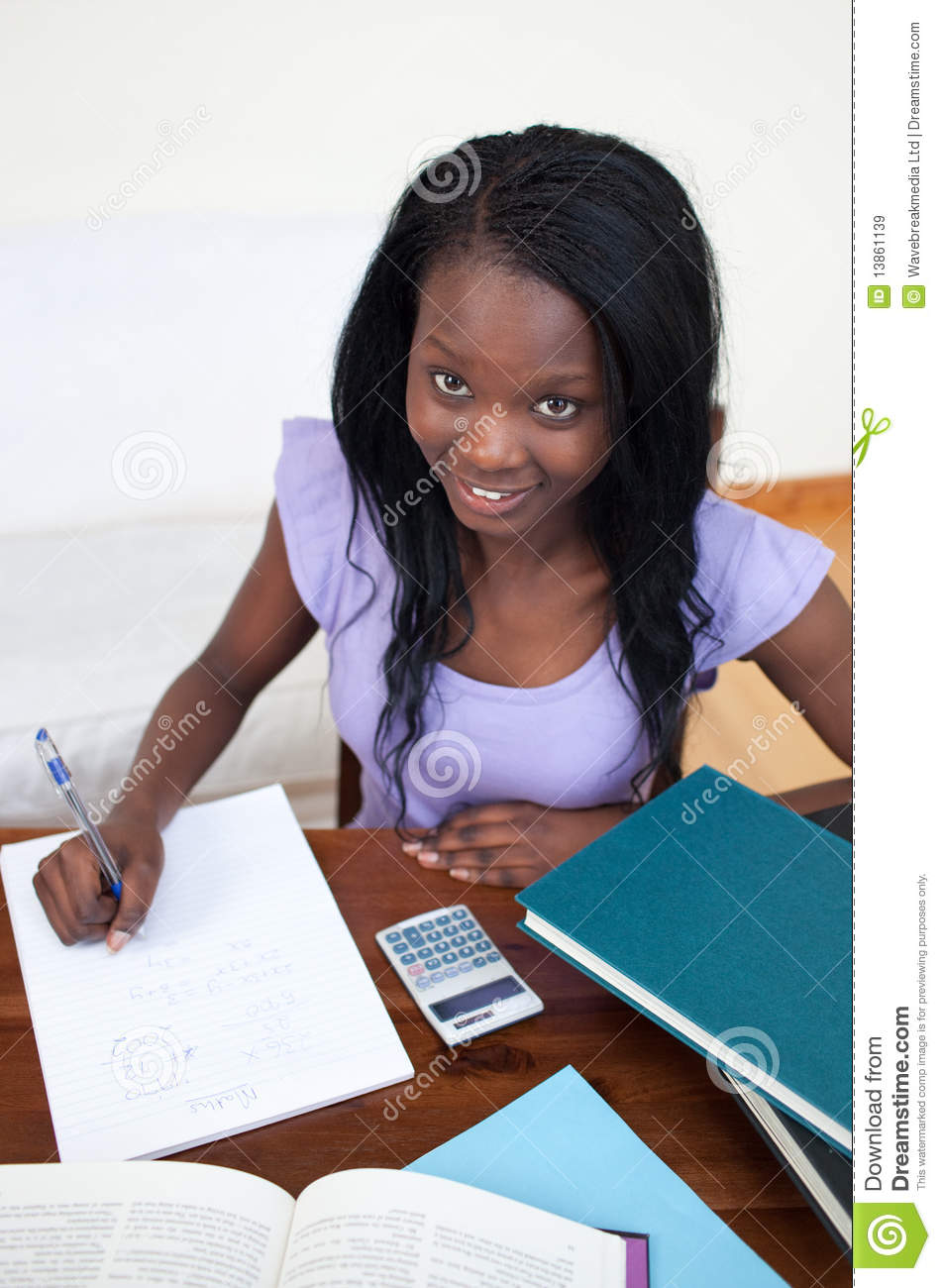 Smiling Afro American Teen Girl Doing Her Homework Royalty Free Stock