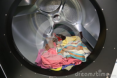 Towels Inside The Drum Of A Huge Industrial Dryer Machine At A Laundry