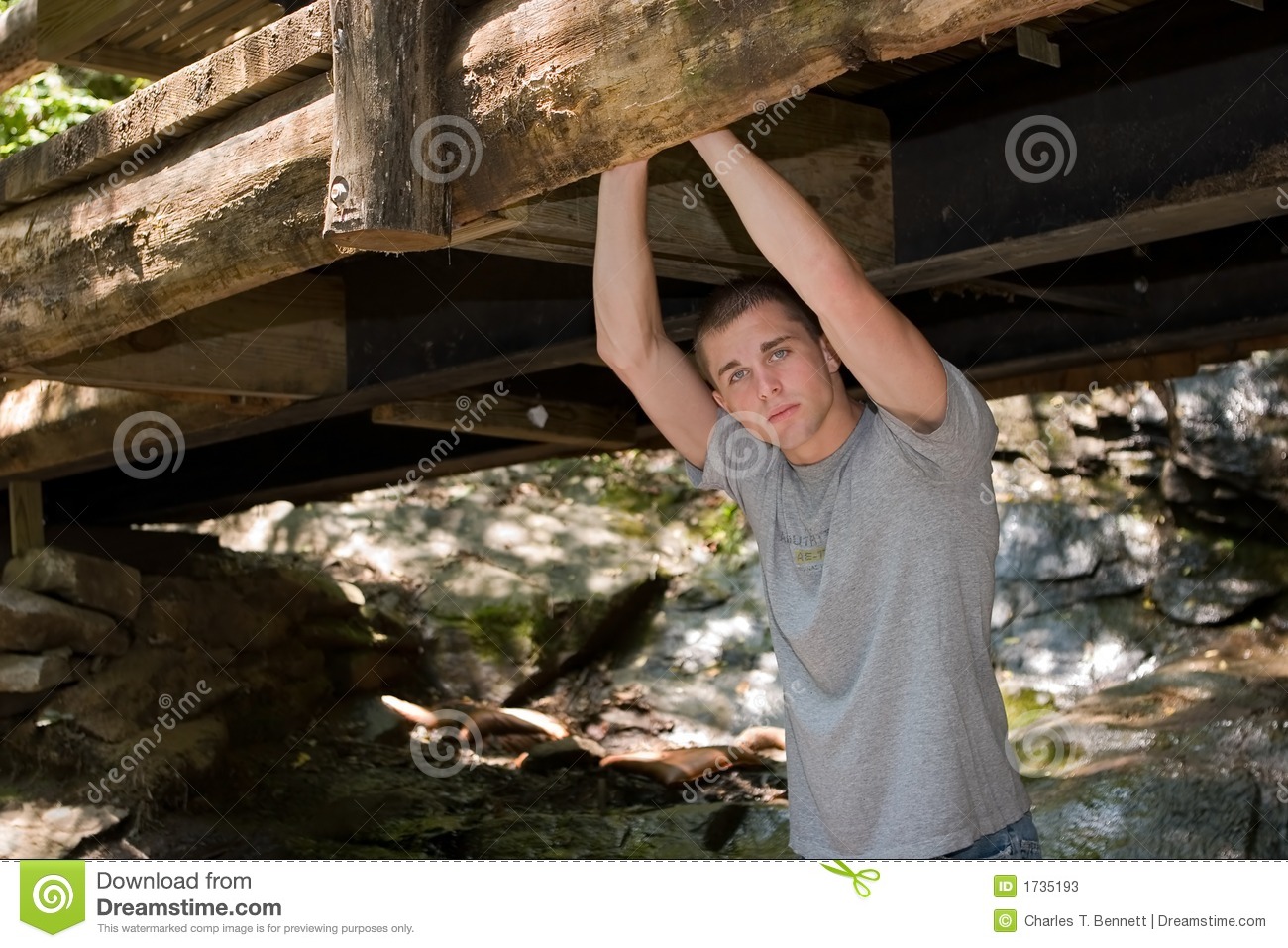 Casual High School Senior Portrait Of Young Man Standing Under A Very