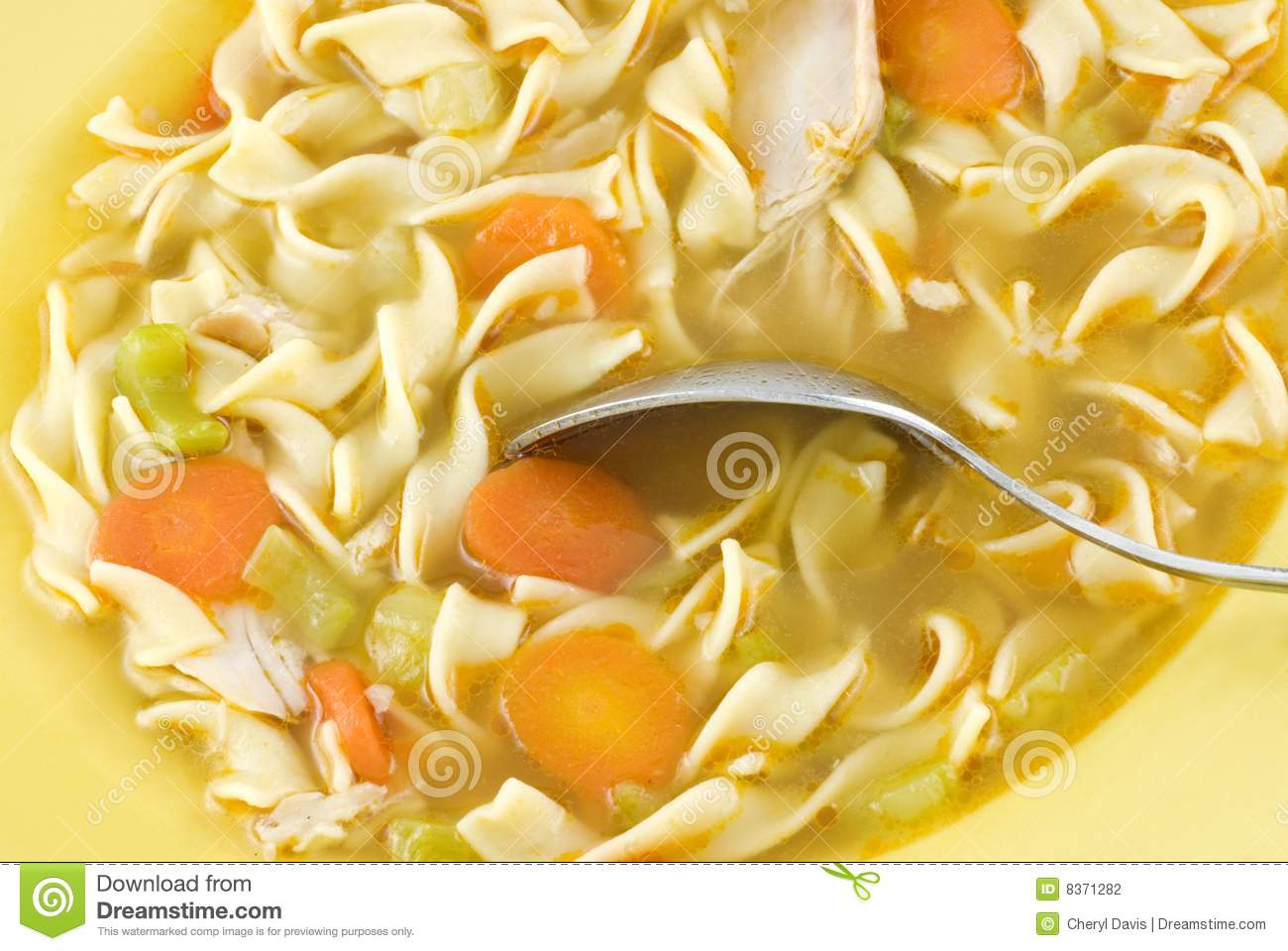 Homemade Chicken Noodle Soup With Carrots And Celery In A Yellow Bowl