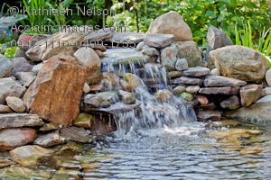 Stock Photography Of A Backyard Water Fountain With A Rocky Waterfall