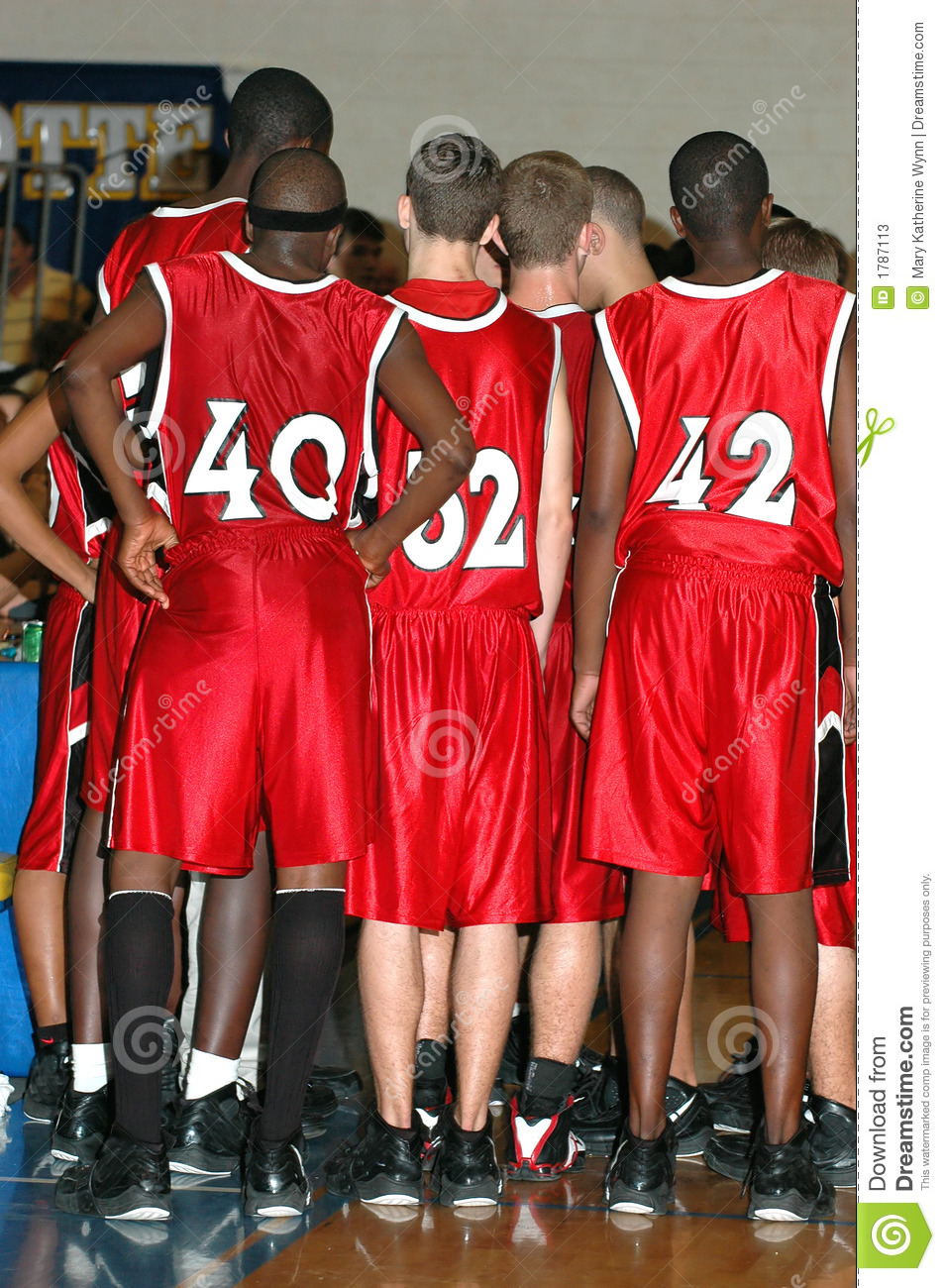 Huddle Of High School Boys Basketball Team During A Time Out 