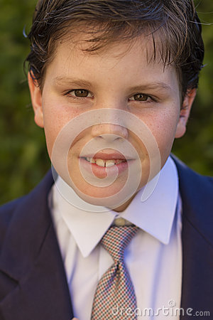 Color Portrait Of Ten Year Old Boy Dressed In Dark Blue Suit And Tie