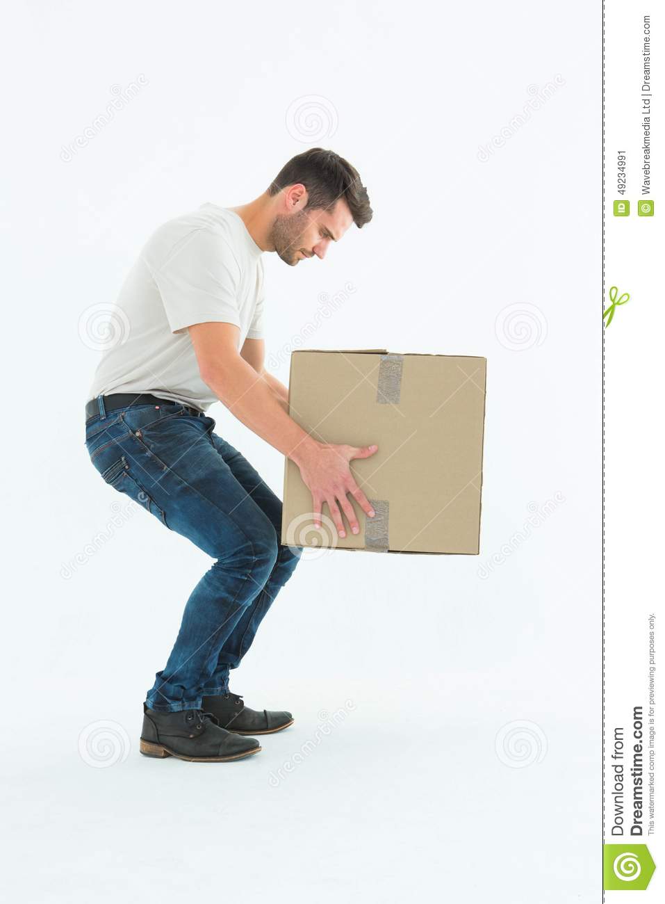 Full Length Side View Of Courier Man Picking Up Cardboard Box On White