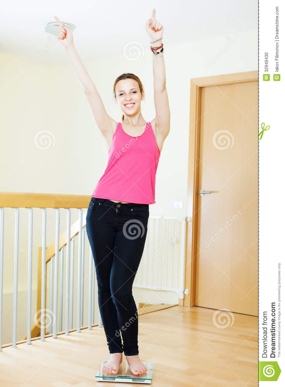 Happy Girl Weighing Herself On Bathroom Scale Stock Photo   Image    