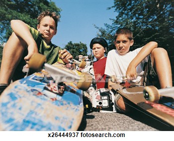Portrait Of A Small Group Of 10 To 13 Year Old Boy Skateboarders View