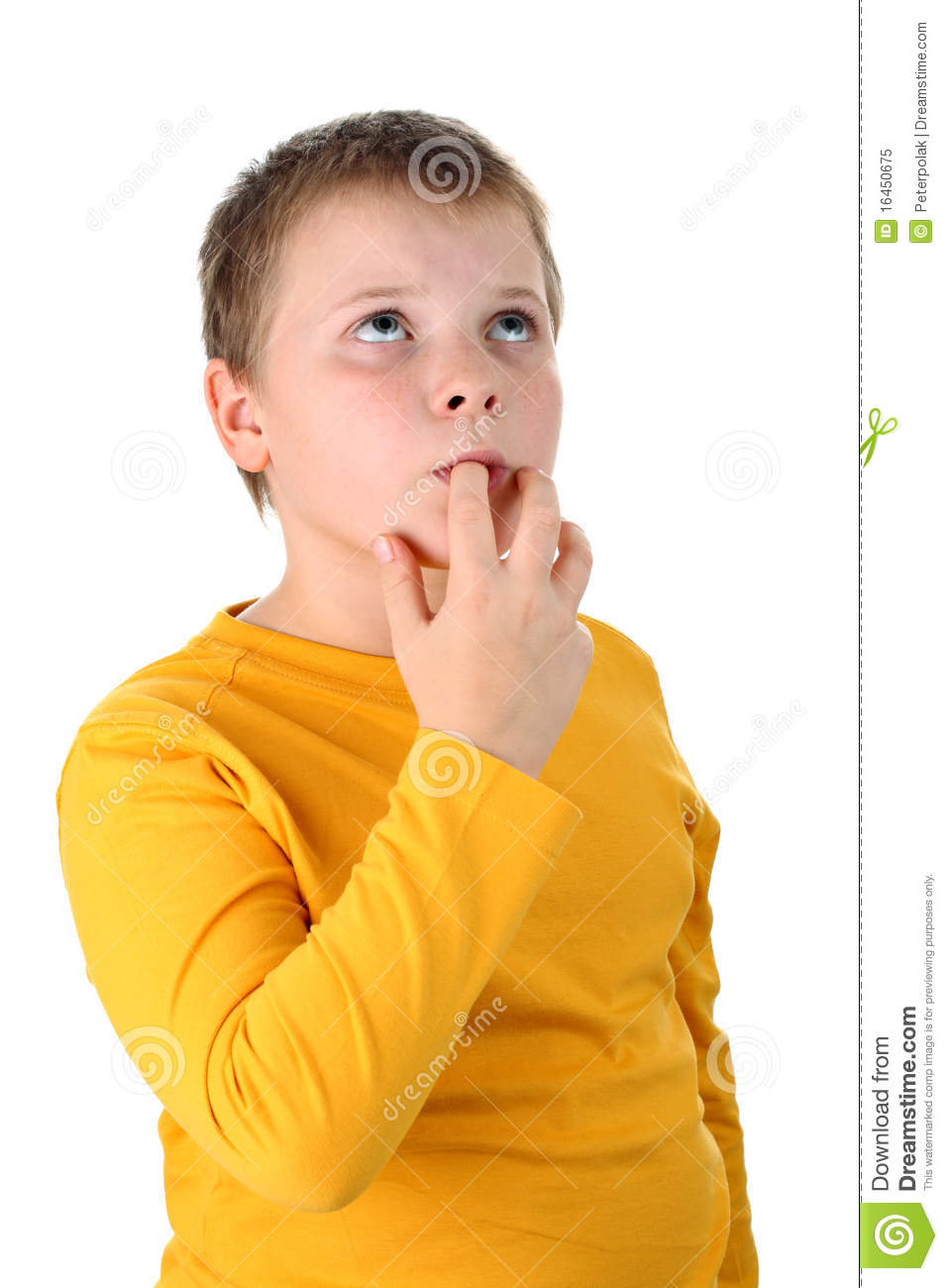 Portrait Of Preteen Boy Tasting Some Food With His Finger Looking Up    