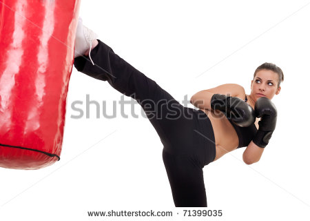 Young Woman Kick A Punching Bag  Isolated On White   Stock Photo