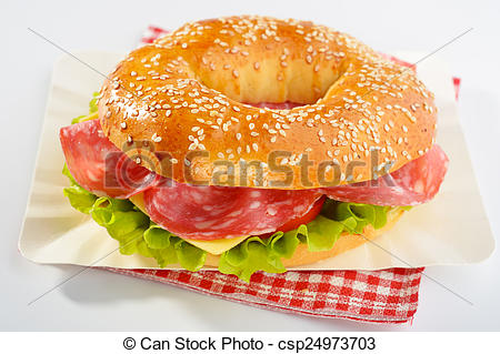 Bagel Sandwich With Sausage Cheese And Lettuce On A Paper Plate