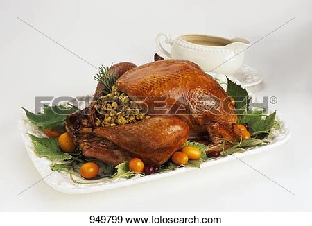 Stuffed Turkey On A Platter With Gravy Boat View Large Photo Image