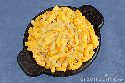 Macaroni And Cheese In A Black Bowl On Blue Background 