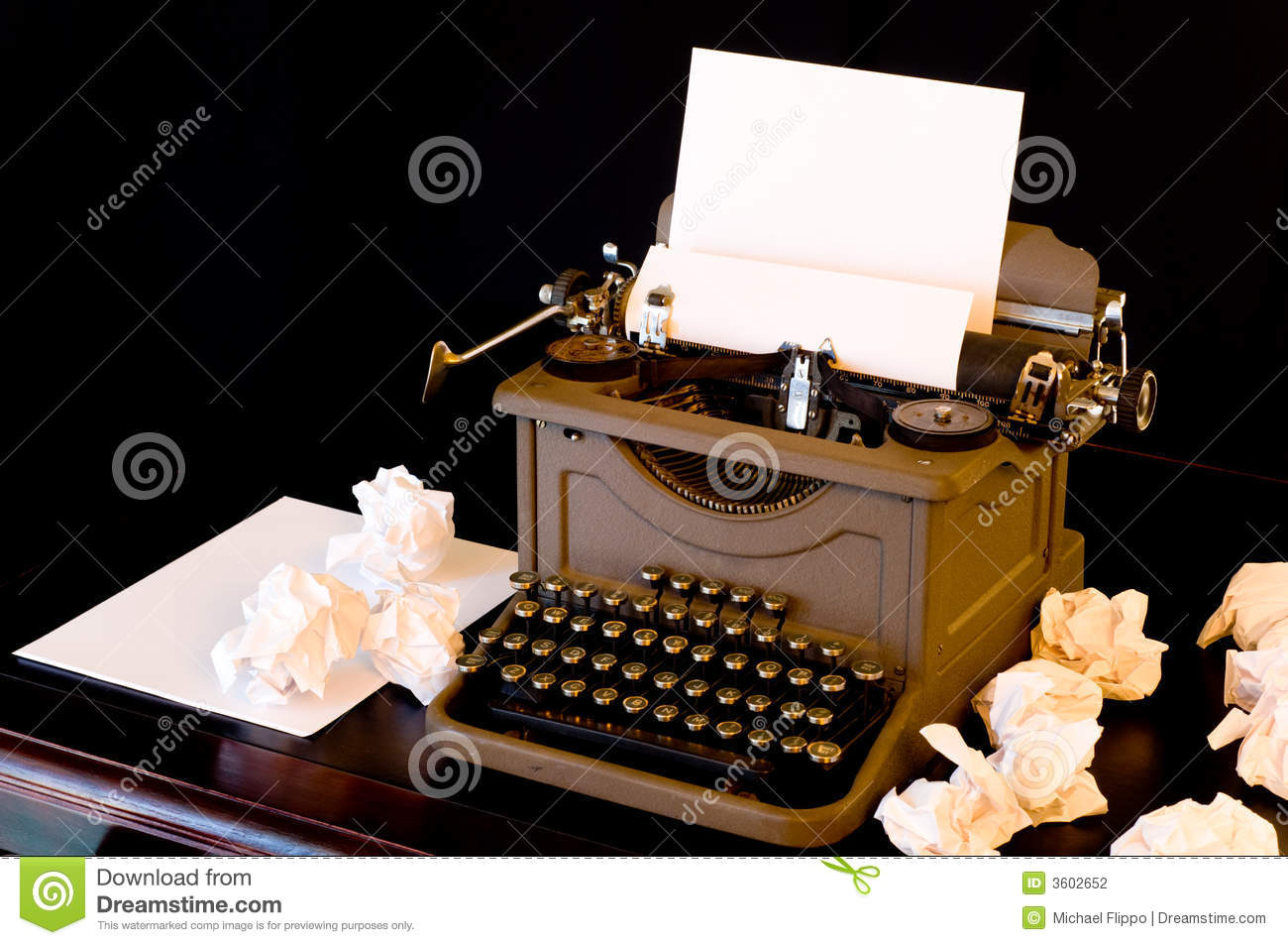 Vaintage Typewriter With Several Wadded Up Pieces Of Paper Arranged