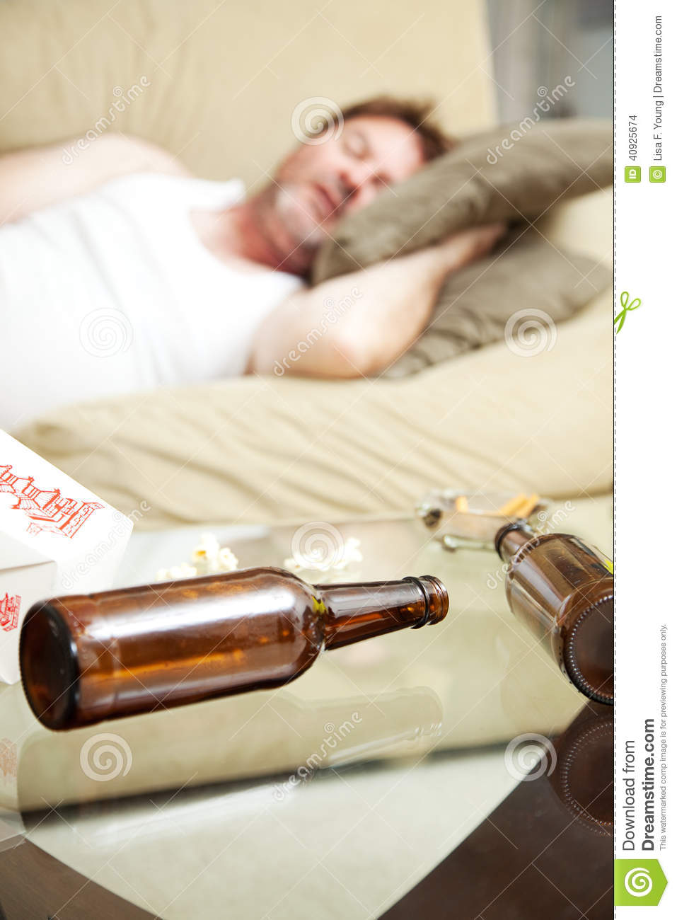 Man Asleep On The Couch With Ashtray Takeout Food Container And Beer    