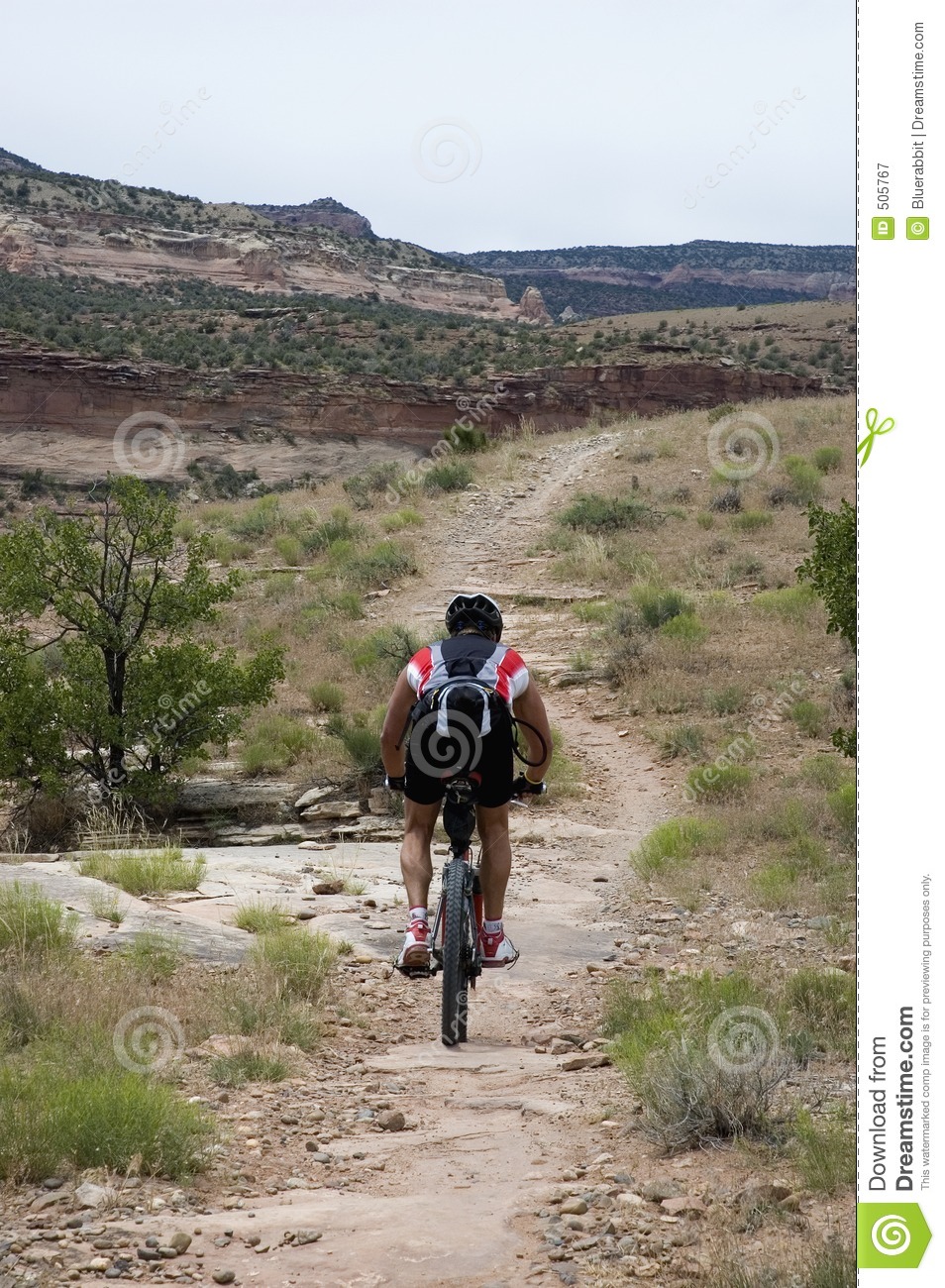 Mountian Biker In A Desert Landscape Above The Colorado River Near