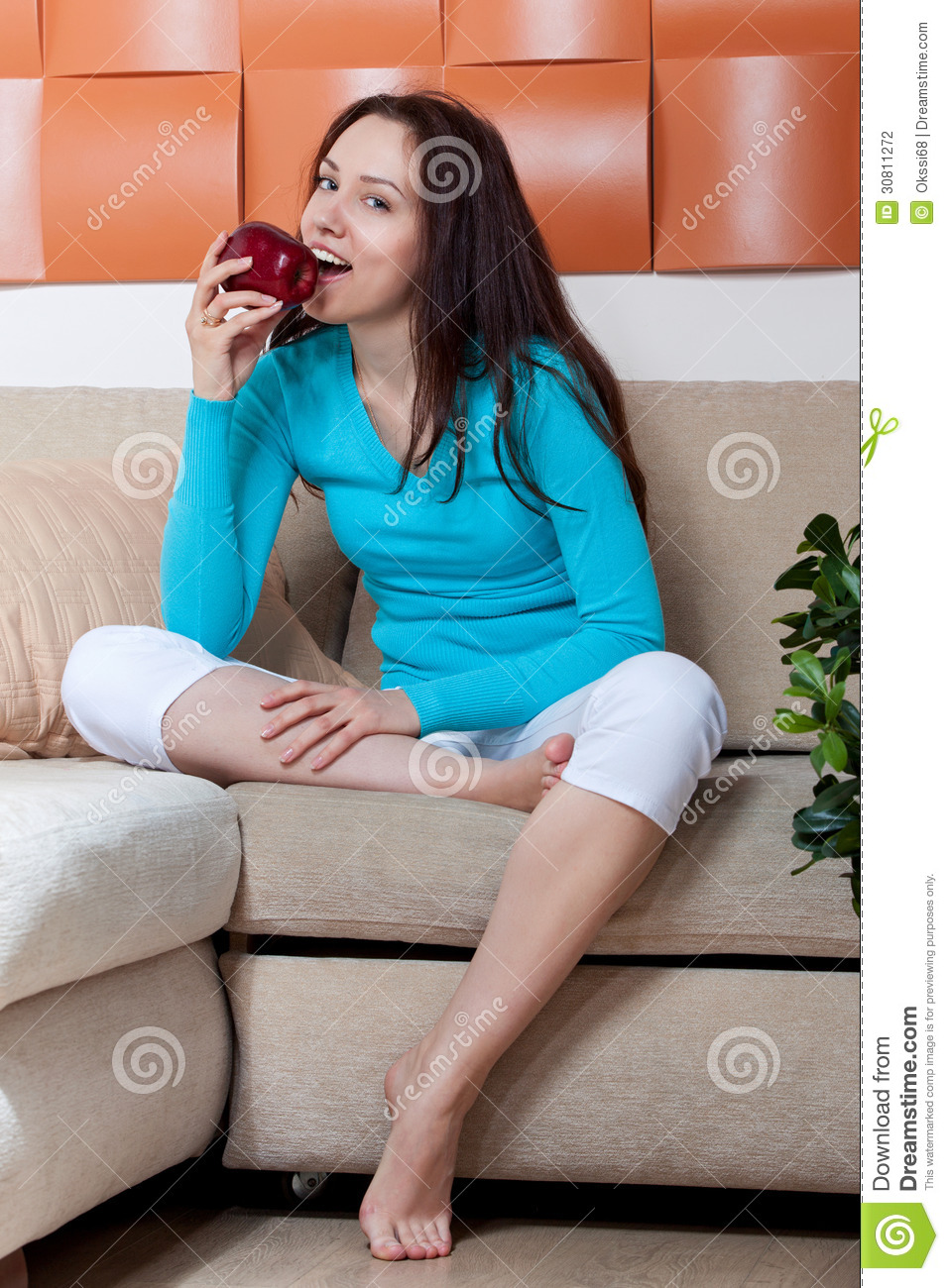 Woman Sitting On The Couch And Eat An Apple Stock Photography   Image    
