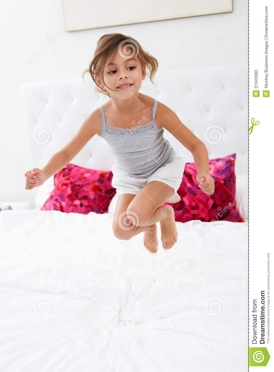 Girl Jumping On Bed Wearing Pajamas Stock Photos   Image  31343383